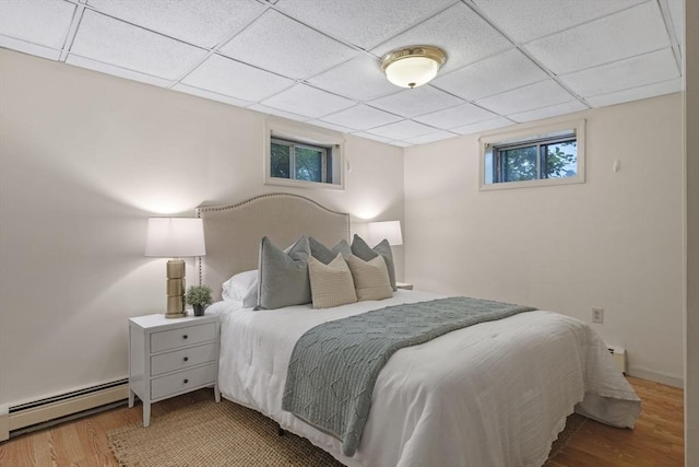 5 Ledgewood Rd, Saugus, MA 01906 - bedroom featuring a baseboard radiator, wood finished floors, and a drop ceiling