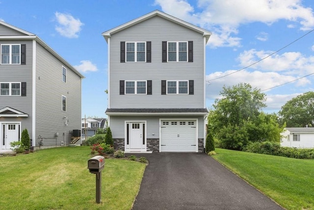 15 Spadina, Warwick, RI 02889 - view of front of property featuring asphalt driveway, a front yard, stone siding, and a garage