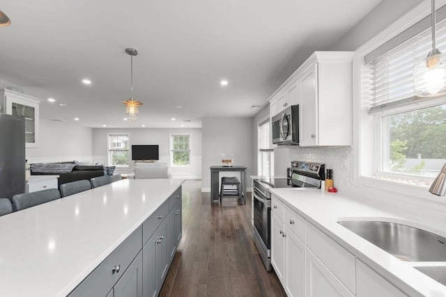 15 Spadina, Warwick, RI 02889 - kitchen featuring appliances with stainless steel finishes, recessed lighting, white cabinetry, dark wood-style flooring, and pendant lighting