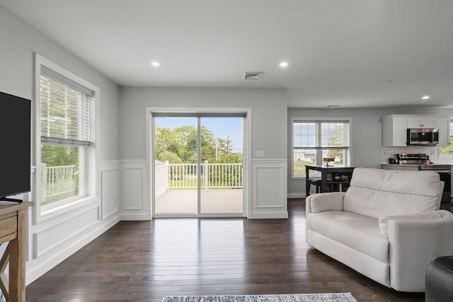 15 Spadina, Warwick, RI 02889 - living room featuring dark wood-style floors, wainscoting, a decorative wall, and recessed lighting