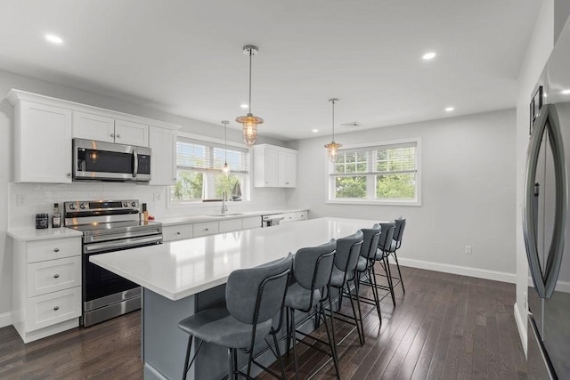 15 Spadina, Warwick, RI 02889 - kitchen featuring appliances with stainless steel finishes, plenty of natural light, light countertops, a breakfast bar area, and recessed lighting