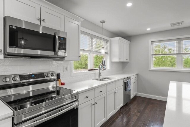 15 Spadina, Warwick, RI 02889 - kitchen featuring appliances with stainless steel finishes, healthy amount of natural light, light countertops, dark wood-style floors, and recessed lighting