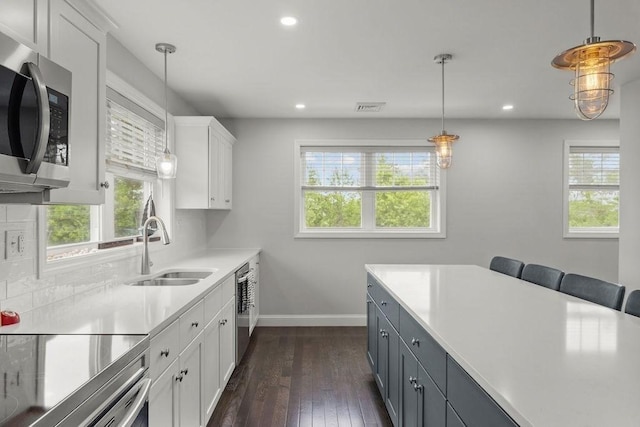 15 Spadina, Warwick, RI 02889 - kitchen featuring appliances with stainless steel finishes, healthy amount of natural light, white cabinetry, light countertops, and recessed lighting