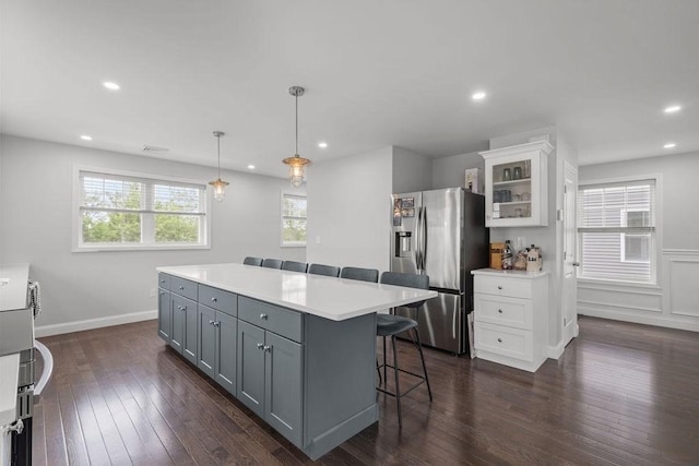 15 Spadina, Warwick, RI 02889 - kitchen with stainless steel fridge with ice dispenser, gray cabinetry, a kitchen bar, white cabinets, and glass insert cabinets