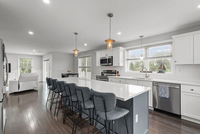 15 Spadina, Warwick, RI 02889 - kitchen with appliances with stainless steel finishes, dark wood finished floors, a breakfast bar, open floor plan, and recessed lighting