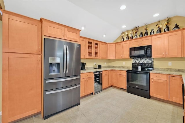 4063 Main St, Palmer, MA 01069 - kitchen with black appliances, wine cooler, vaulted ceiling, glass insert cabinets, and light stone countertops