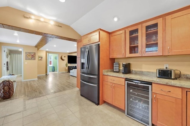 4063 Main St, Palmer, MA 01069 - kitchen with wine cooler, stainless steel fridge with ice dispenser, lofted ceiling, glass insert cabinets, and light tile patterned flooring