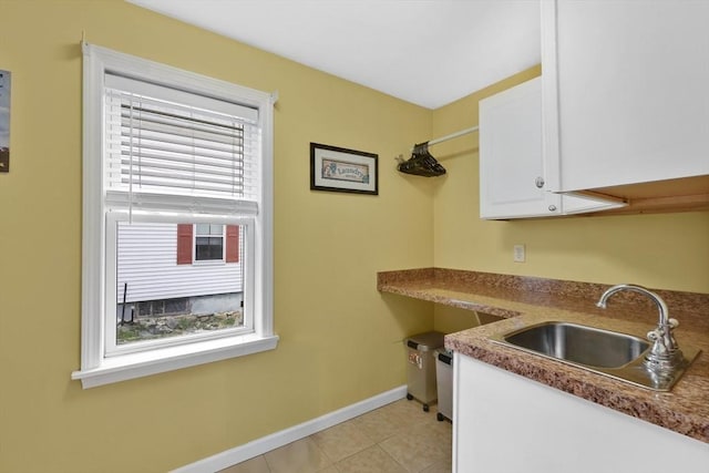4063 Main St, Palmer, MA 01069 - laundry area featuring a sink, baseboards, and light tile patterned flooring