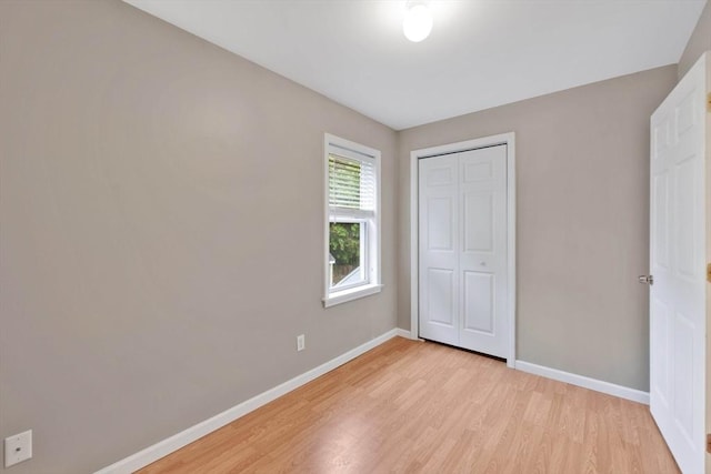 4063 Main St, Palmer, MA 01069 - unfurnished bedroom with light wood finished floors, baseboards, and a closet