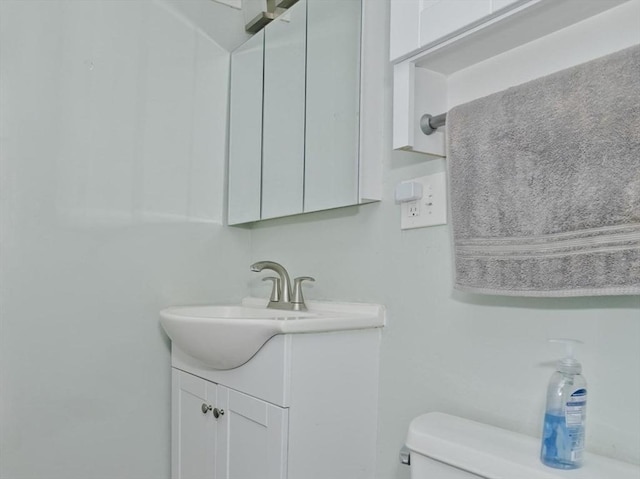 half bathroom with toilet and vanity