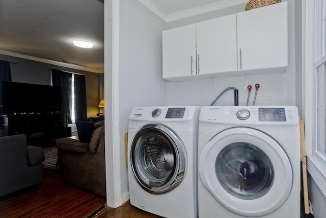 laundry area featuring dark wood-style floors, separate washer and dryer, crown molding, and cabinet space