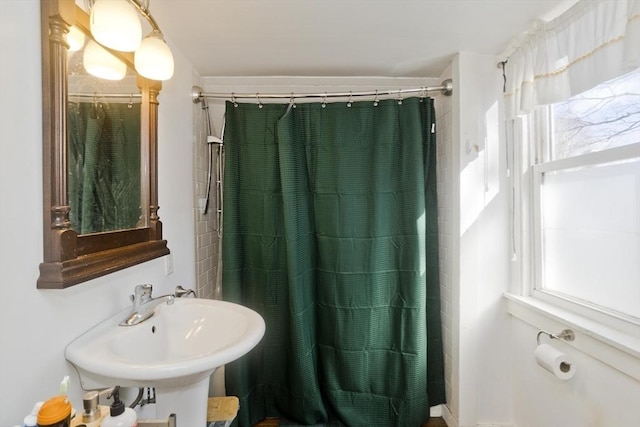 bathroom featuring a shower with curtain and a sink
