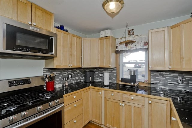 kitchen with light brown cabinets, backsplash, and appliances with stainless steel finishes