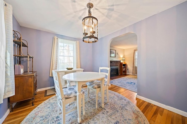 40 Mamie Rd, Weymouth, MA 02190 - dining room with arched walkways, baseboards, and wood finished floors
