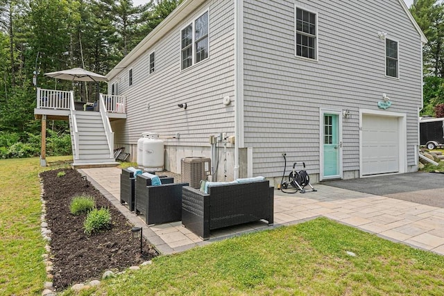 61 Hingham Ave, Marshfield, MA 02050 - rear view of house featuring stairway, a garage, central AC unit, a deck, and asphalt driveway
