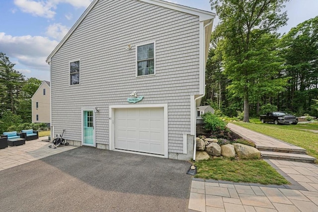 61 Hingham Ave, Marshfield, MA 02050 - view of property exterior with an attached garage, an outdoor living space, and asphalt driveway