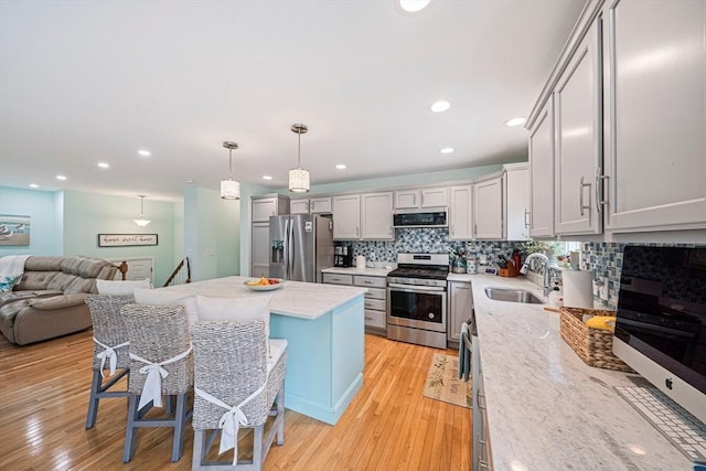 61 Hingham Ave, Marshfield, MA 02050 - kitchen with appliances with stainless steel finishes, extractor fan, a sink, decorative backsplash, and light wood-type flooring