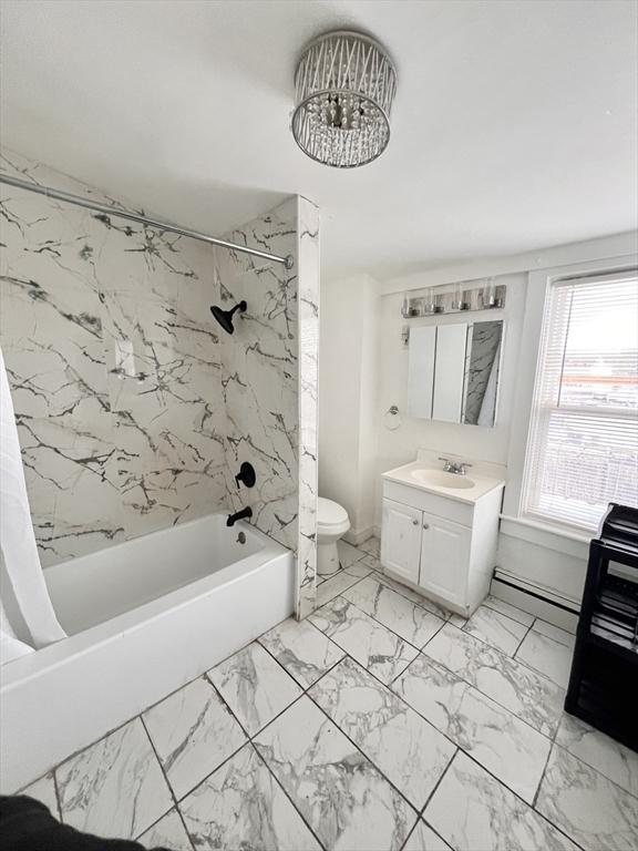 full bathroom featuring toilet, a baseboard radiator, marble finish floor, shower / bathtub combination with curtain, and vanity