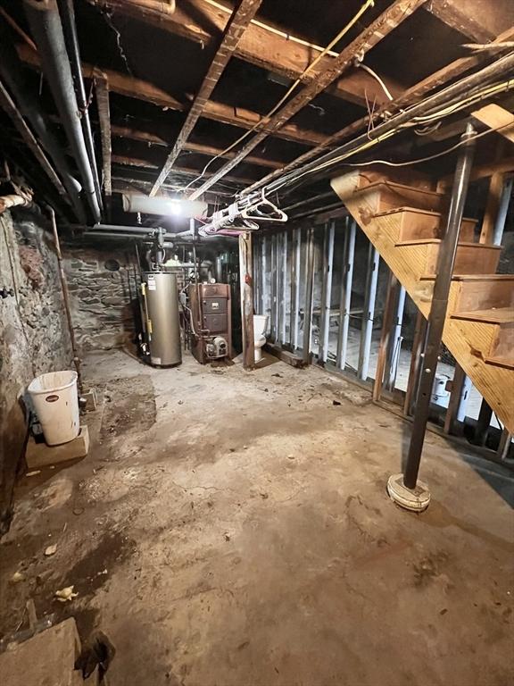 unfinished basement with a heating unit and water heater