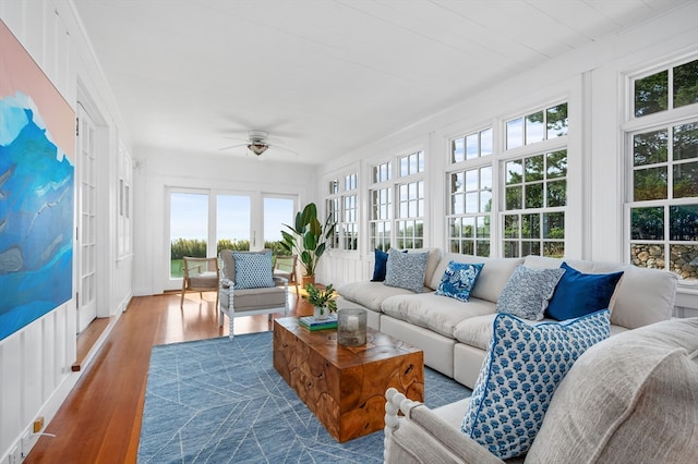 sunroom / solarium featuring ceiling fan