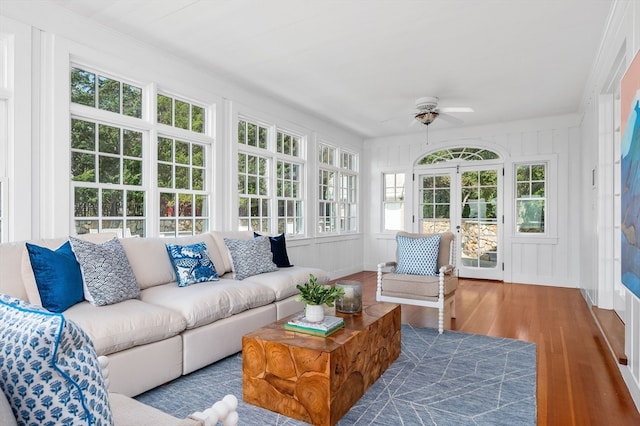 sunroom featuring ceiling fan and a healthy amount of sunlight