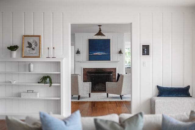 living room featuring wood-type flooring and a fireplace