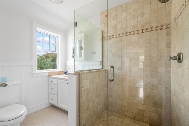 bathroom featuring vanity, a shower with shower door, toilet, and tile patterned flooring