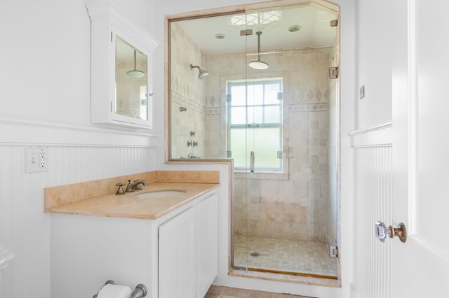 bathroom featuring vanity and a shower with shower door