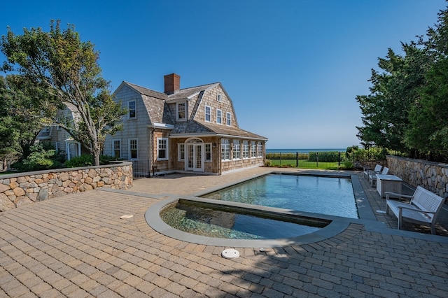 view of pool featuring french doors and a patio area