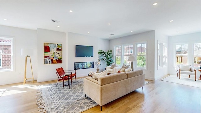 140 Columbia St, Brookline, MA 02446 - living room featuring light wood finished floors, baseboards, and recessed lighting