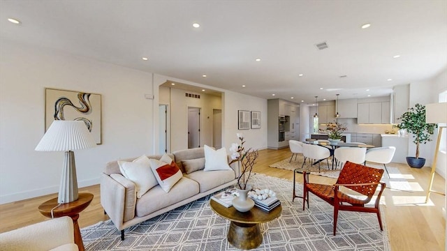140 Columbia St, Brookline, MA 02446 - living area featuring light wood-style floors, recessed lighting, and baseboards