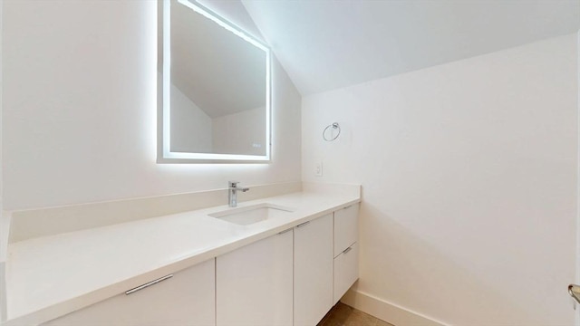 140 Columbia St, Brookline, MA 02446 - bathroom with vanity, lofted ceiling, and baseboards