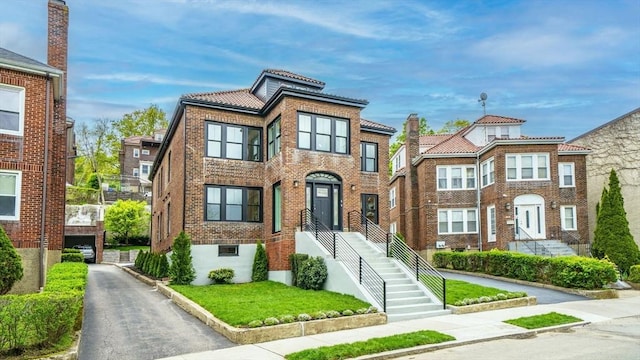 140 Columbia St, Brookline, MA 02446 - view of property featuring a tiled roof and brick siding