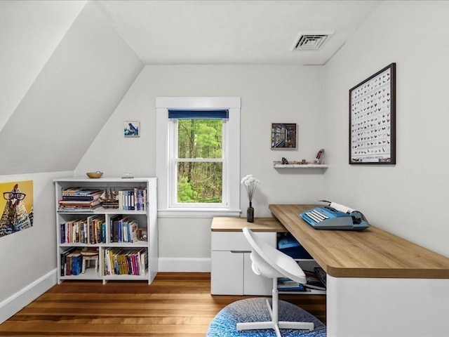 office space with wood finished floors, baseboards, and vaulted ceiling