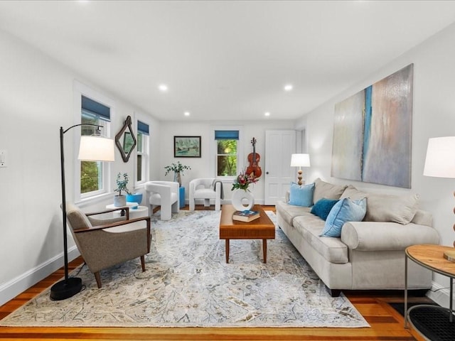 living area featuring wood finished floors, recessed lighting, and baseboards