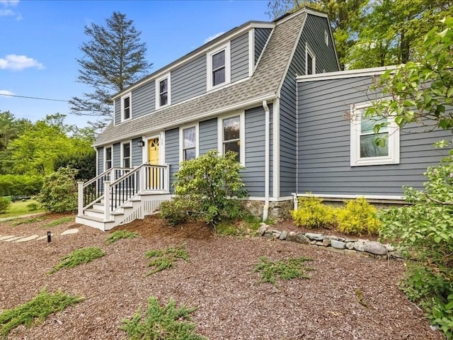 dutch colonial with a shingled roof and a gambrel roof