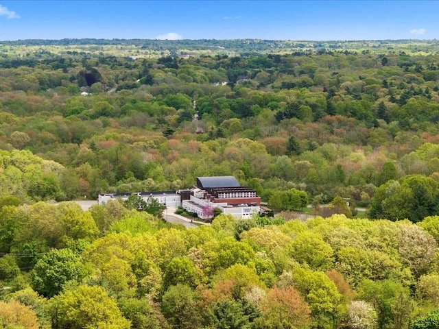 view of subject property featuring a heavily wooded area