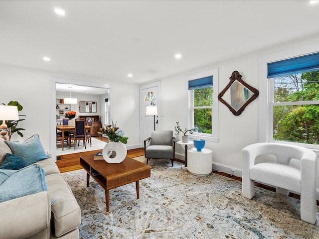 living room featuring wood finished floors, recessed lighting, and baseboards