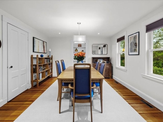 dining area with wood finished floors, baseboards, and recessed lighting