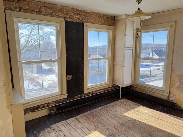 interior details featuring crown molding and hardwood / wood-style floors