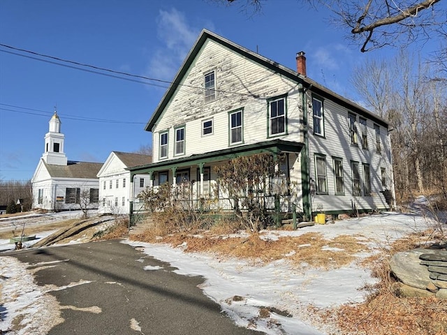 view of snow covered exterior with covered porch