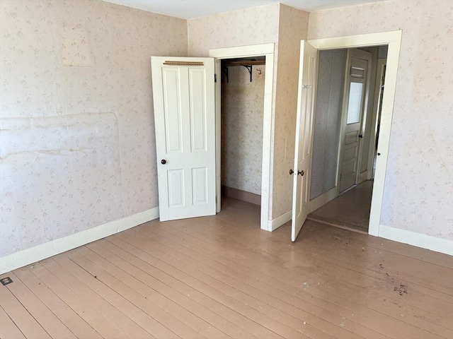 unfurnished bedroom with wood-type flooring