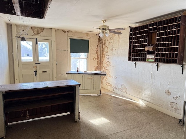 interior space featuring cream cabinetry and ceiling fan