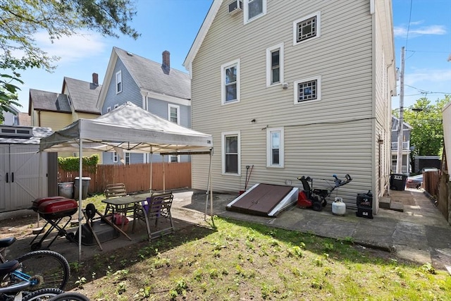rear view of property with a gazebo, fence, and a patio area