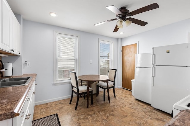 kitchen with freestanding refrigerator, a sink, ceiling fan, white cabinets, and recessed lighting