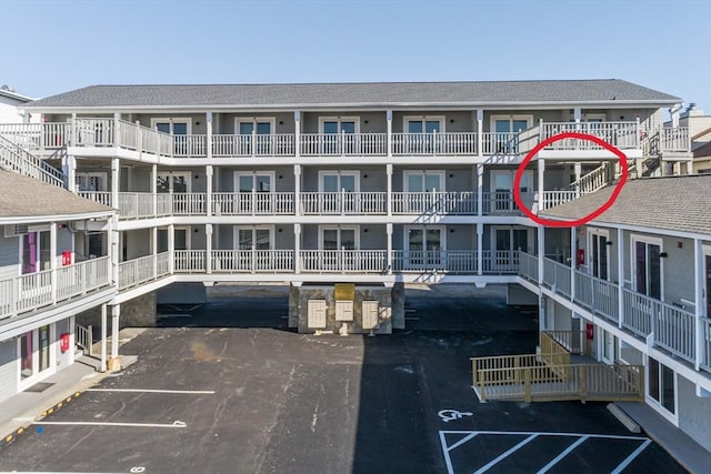 view of apartment building / complex with uncovered parking