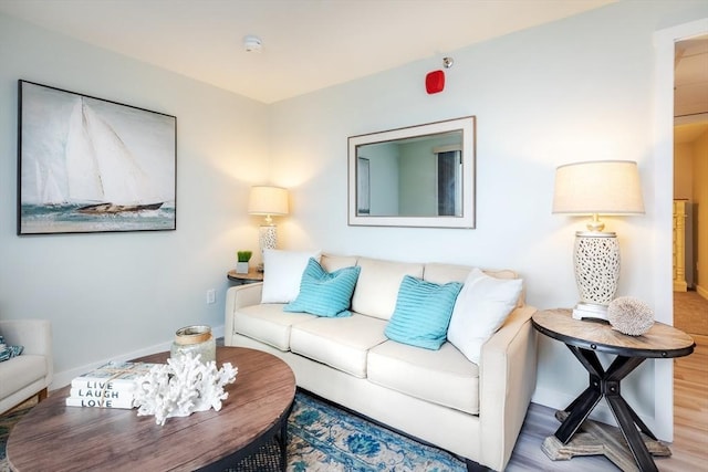 living area with wood finished floors and baseboards