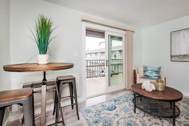 doorway with wood finished floors and baseboards