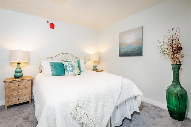 bedroom featuring carpet floors and baseboards
