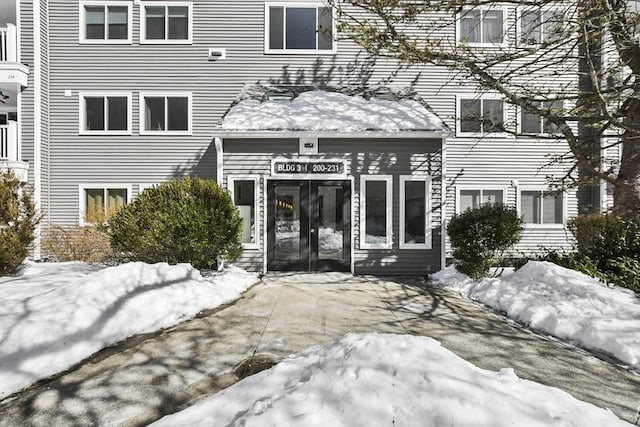 view of snow covered property entrance